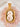 Two round, off-white bath bombs decorated with dried pink and yellow flower petals sitting in a light-colored wooden scoop, surrounded by smooth pink rose quartz stones.