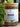Glass jar of Megan & Co. Honest Tox tea blend with a wooden lid on a blurred natural background.