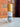 Megan & Co. Mag Mist bottle on a marble surface with a brick wall background