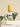 Purify room and body spritzer in a clear bottle with a wooden cap, staged on layered white marble with a fresh eucalyptus stem in the background.