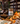 Glass jar with dried orange peel set on a table in a room with more glass jars in the background.