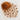 A small mound of rich, reddish-brown cacao powder scattered across a white marble surface.