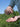 Person holding a vial over an open palm with a green outdoor background