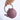 Purple teapot with gold patterns held by a hand on a light purple background