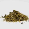 Pile of dried green herbs on a white background
