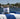 Jar of Megan & Co. tea on a blue and white striped towel with a blurred waterfront background