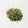 A 28g mound of dried, chopped green boneset leaves and stems centered on a solid white surface.