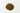 A small mound of reddish-brown, woody cassia cinnamon chips centered on a plain white surface.