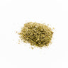 A small mound of dried, green-brown catnip leaves and stems centered on a plain white surface.