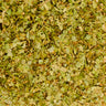 A dense, overhead view of dried gotu kola aerial parts, featuring a vibrant mixture of small, fragmented green leaves and pale stems.