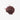 A small, centered mound of dried hibiscus flower petals, featuring a deep burgundy and crimson color with a slightly curled, leathery texture on a plain white surface.