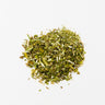 A small, centered mound of dried lobelia aerial parts, consisting of a mix of finely chopped green leaves and small yellow-tan stem fragments, staged on a clean white background.