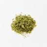 A small, centered mound of dried marshmallow leaf, appearing as soft, fuzzy green herbal fragments with a slightly muted, silvery-green tone, staged on a clean white background.
