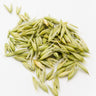 A cluster of whole, dried green oat tops (milky oats) with their husks intact, scattered on a clean white background.