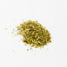 A small mound of dried passionflower aerial parts, featuring a blend of finely chopped green leaves, thin vine fragments, and yellowish-tan stem pieces, staged on a clean white background.