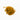 A small mound of dried turmeric root pieces, featuring small, irregular chunks in a deep golden-yellow to orange-brown color, placed on a clean white background.