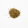 A small, centered mound of dried yellow dock root pieces, consisting of coarse, irregular herbal granules in a mix of earthy olive-green and tan tones, placed on a clean white background.