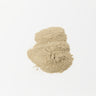 A small mound of fine, light tan burdock root powder displayed against a clean white background.