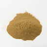 A smooth, rounded mound of fine-textured, light brown dandelion root powder centered on a clean white surface.