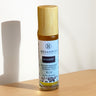 Megan & Co. Bouquet roll-on bottle on a wooden surface with a white background