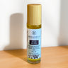 Megan & Co Boji Bliss roll-on bottle on a wooden surface with a white background