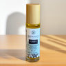 Roll-on bottle of Megan & Co. Purify on a wooden surface with a neutral background