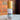 Megan & Co. Mag Mist bottle on a marble surface with a brick wall background