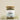 A glass jar containing loose leaf tea, with a label that reads 'Megan & Co. Nourish + Care'.