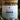 Megan & Co. Chest Re-Leaf tea in a glass apothecary jar with a bamboo lid, surrounded by eucalyptus leaves at the bottom with a soft, blurry background.