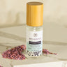 Megan & Co. Lavender Toner Hydrosol with a bamboo cap on a white marble slab with dried purple lavender buds at the base.