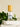 Megan & Co. Sacred Bloom Essence Spritzer with a bamboo cap on layered white marble stones with fresh green leaves at the base.