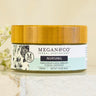 Megan & Co Nursing Cream jar with bamboo lid on a white marble slab with white baby's breath flowers.