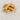 A small stack of six rectangular Palo Santo wood sticks with a smooth, light-tan grain, accompanied by several small wood shavings, resting on a white marble surface with light grey veining.