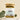 A glass jar containing dried herbal tea leaves with a label that reads 'Peaceful Prairie Tea Blend'. The jar is placed on a neutral background alongside some green foliage.