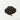A small, centered mound of dark, fine-cut loose leaf black tea characteristic of an English Breakfast blend on a plain white surface.