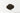 A small, centered mound of dark, fine-cut loose leaf black tea characteristic of an English Breakfast blend on a plain white surface.