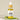 A glass jar with a dropper contains yellow liquid, placed on a white surface with a green leaf in the background. The label reads 'Transform'.