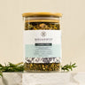 Tea canister with wooden lid labeled 'Megan & Co' on a neutral background