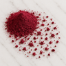 A 28g mound of fine, deep magenta beet root powder scattered across a white marble surface.