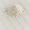 A small, peaked mound of fine white kaolin clay powder resting on a light grey veined marble surface. The powder has a soft, matte texture with some small natural clumps visible at the base of the pile.