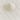 A small, peaked mound of fine white kaolin clay powder resting on a light grey veined marble surface. The powder has a soft, matte texture with some small natural clumps visible at the base of the pile.