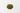 A 28g small mound of dried, oval-shaped brown anise seeds centered on a solid white surface.