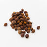 A small mound of whole, dried hawthorn berries featuring a deep brownish-red color and a naturally wrinkled, matte texture on a plain white surface.