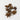 A 28g scattering of whole brown star anise pods on a clean, solid white surface.