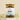 A glass jar containing loose leaf herbal tea blend with a label that reads 'MEGAN & CO. Women's Daily'.