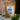 A 1oz sample bag of Megan & Co. Chest Re-Leaf tea on a table, staged with leaves at the base and a blurred brick wall in the background.