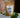 A 1oz sample bag of Megan & Co. Chest Re-Leaf tea on a table, staged with leaves at the base and a blurred brick wall in the background.